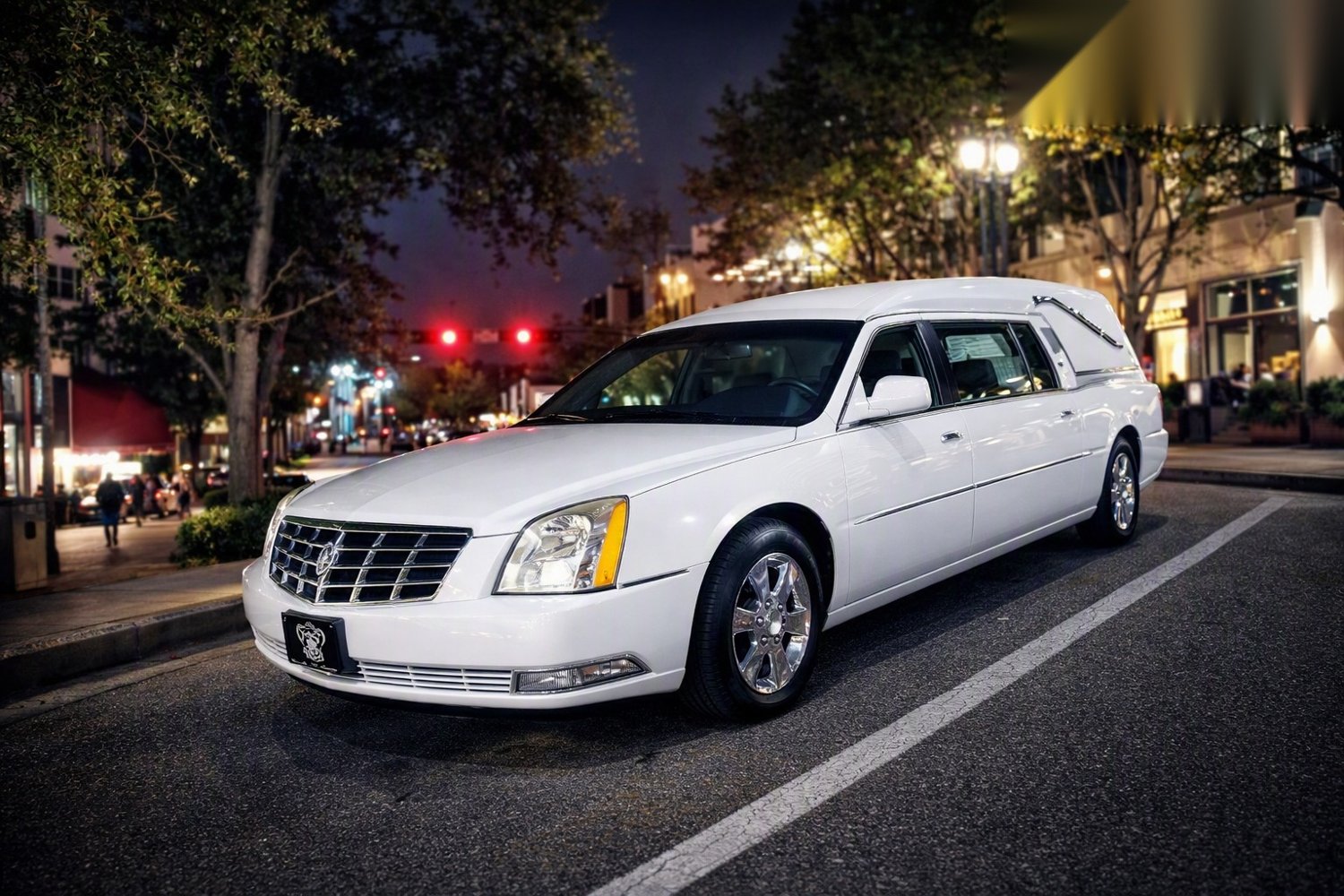 A white hearse on a downtown St. Petersburg street at dusk